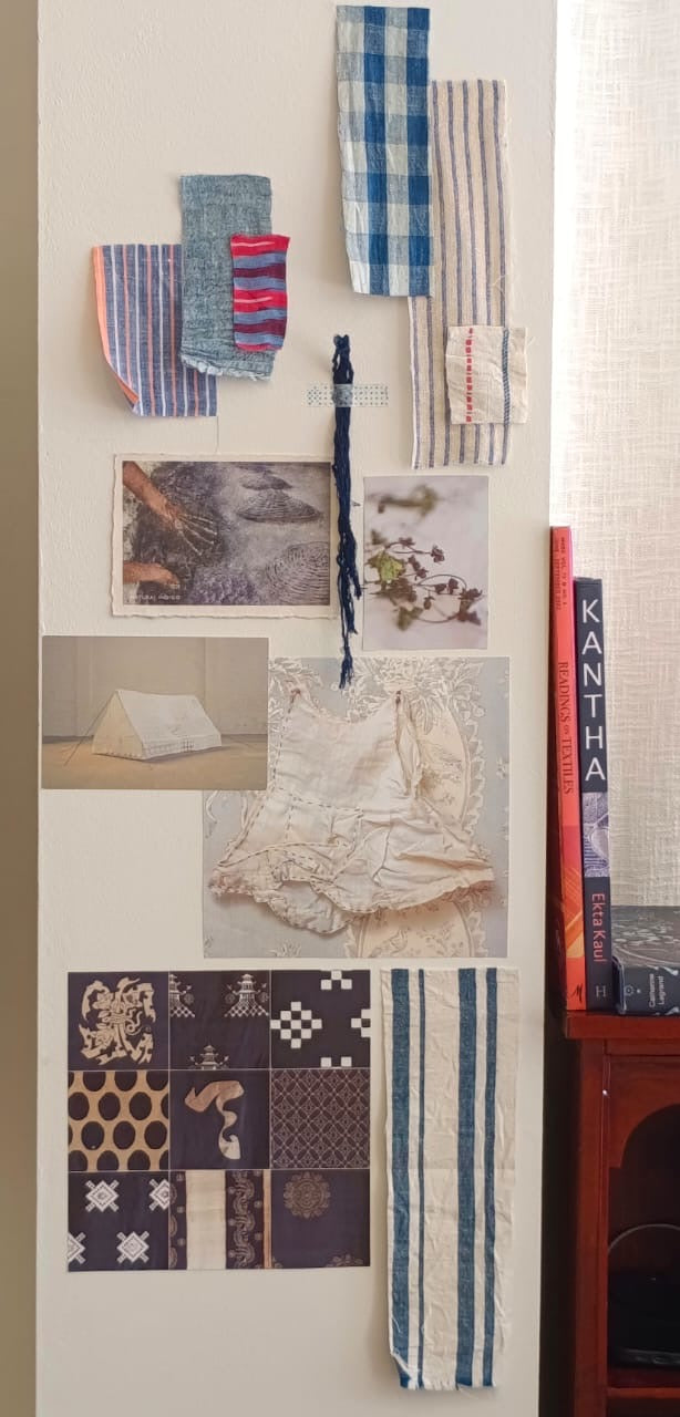 collection of pictures and fabric samples making a moodboard on the wall of the ATELIER A.PUUR.A store 