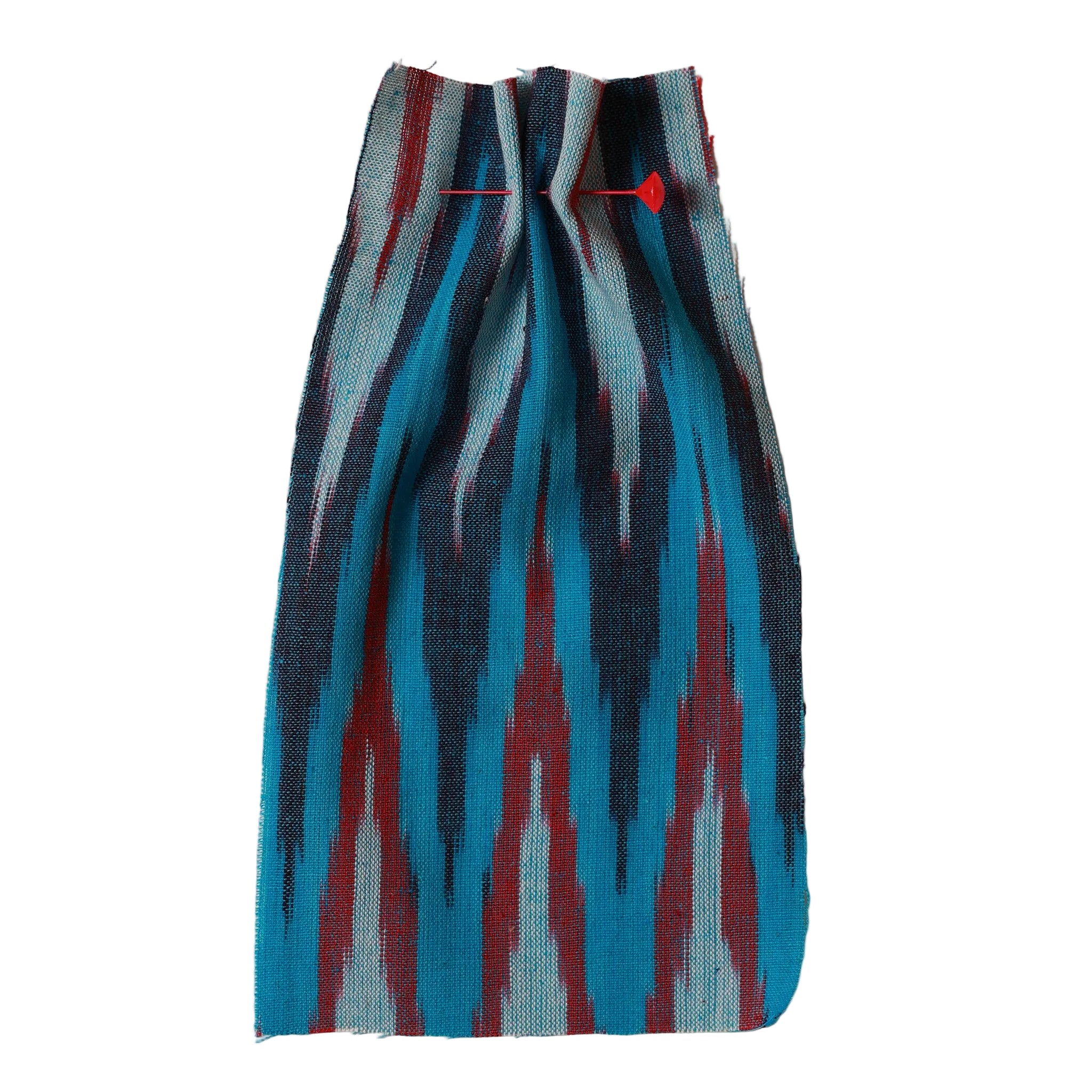Textile with blue, red, and black pattern on a beige background. Ikat collection ATELIER A.PUUR.A 