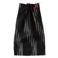 Black and white Ikat striped fabric with red accents on a beige background. Fabric collection ATELIER A.PUUR.A