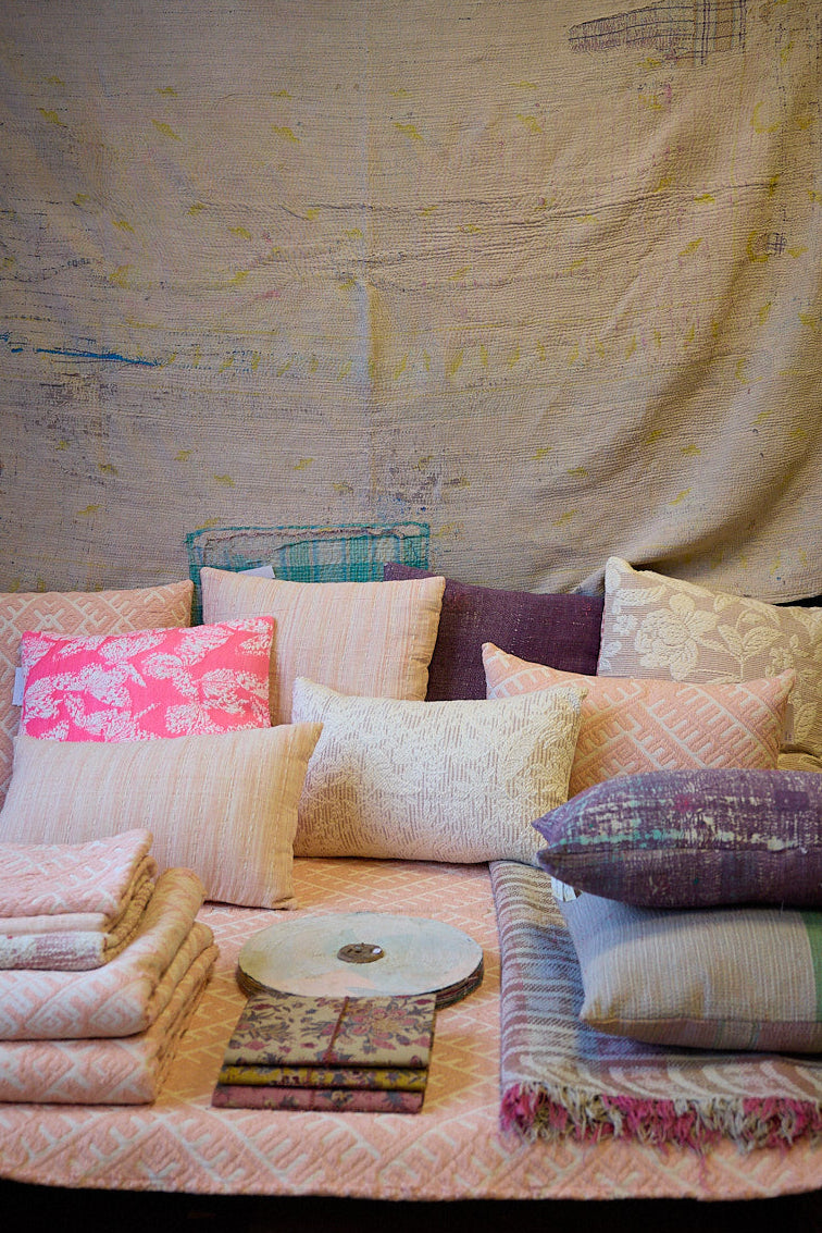 A display a different cushions, plaids and textiles of the interior collection of ATELIER A.PUUR.A 