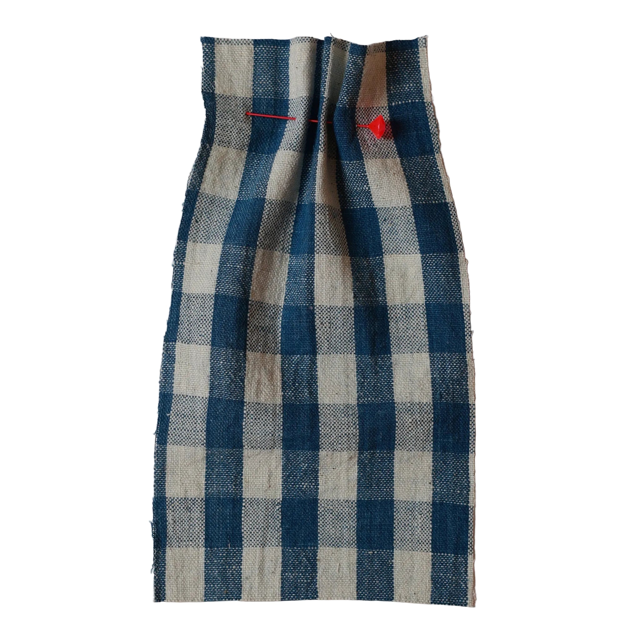 Blue and white checkered fabric with red pins on a beige background. Collection ATELIER A.PUUR.A 