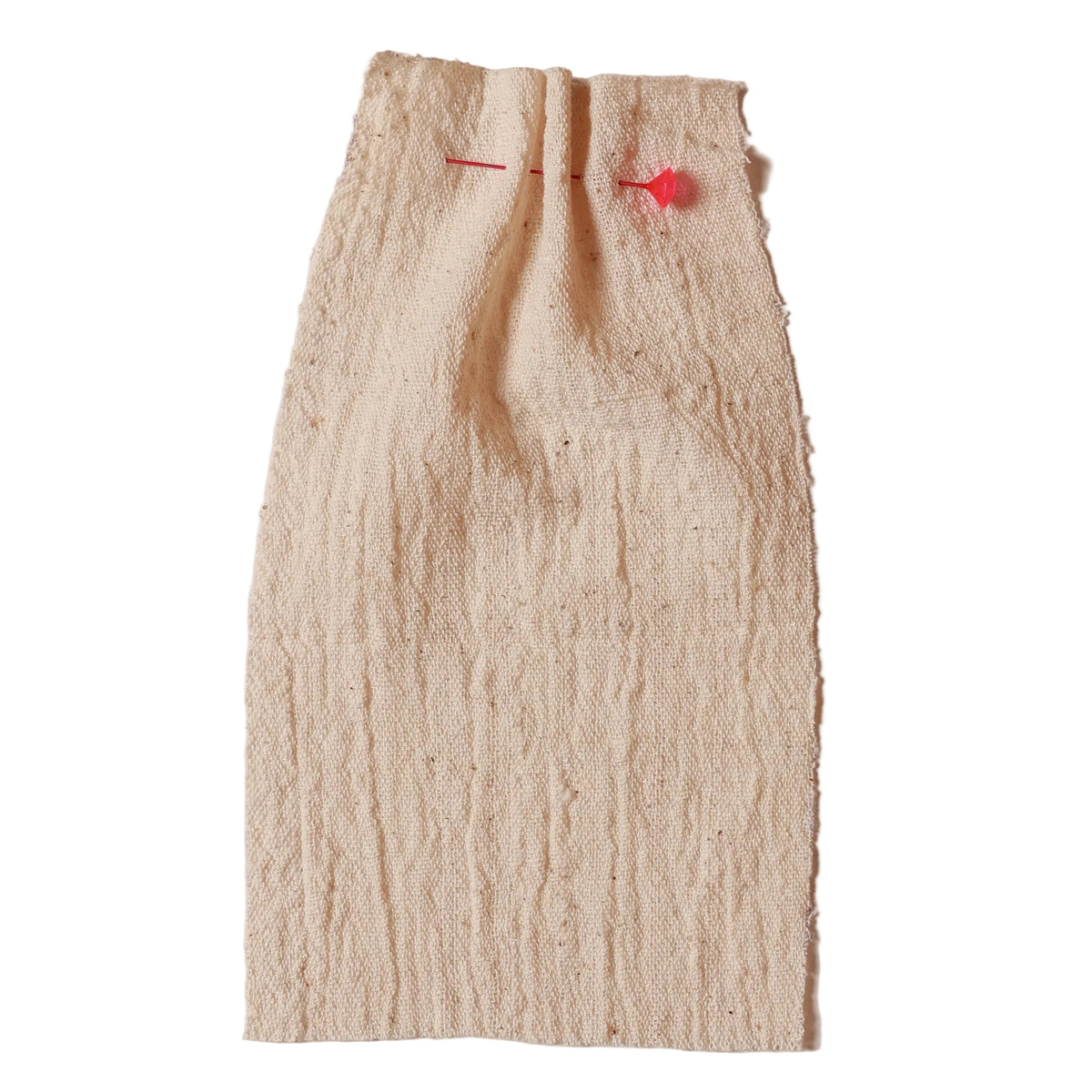Beige textured fabric with red pins on a beige background. Collection ATELIER A.PUUR.A 