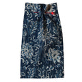 Printed Blue floral patterned fabric with a red needle on a beige background